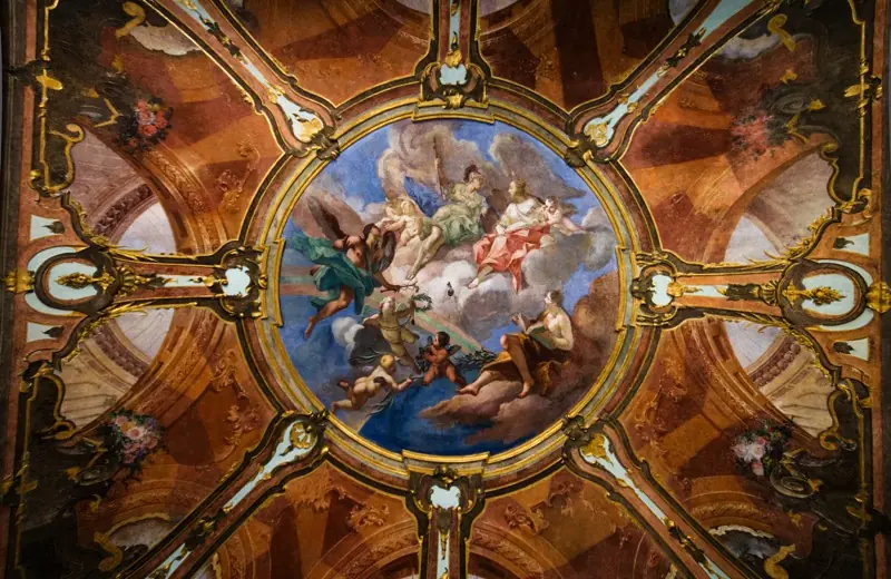 Un soffitto affrescato del palazzo, con figure allegoriche al centro di una cornice decorata